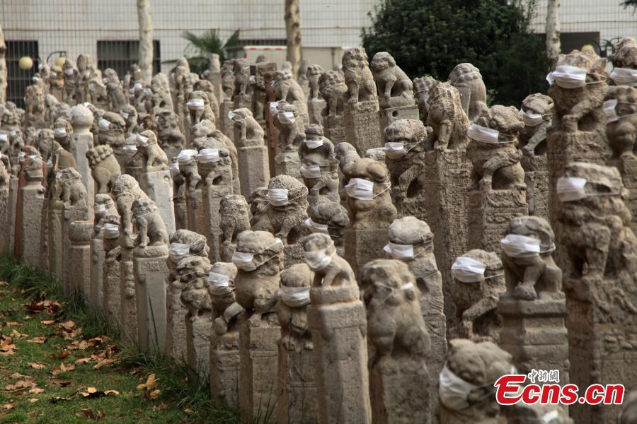Estudantes colocam máscaras em le?es de pedra em protesto contra a polui??o do ar